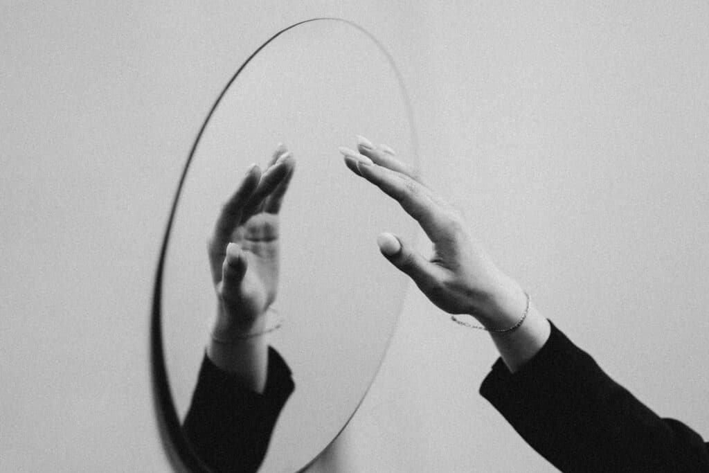 A Mirror Showing A Reflection Of An Arm