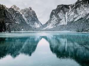body of water and snow-covered mountains during daytime